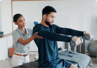 A physical therapist helping a patient with dumbbell exercises.